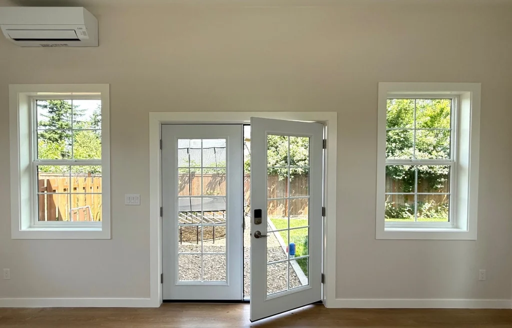 Bright backyard room with French doors and wood-look flooring