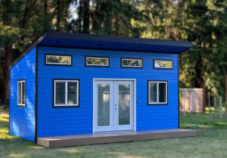 Blue backyard office shed with clerestory windows and French doors