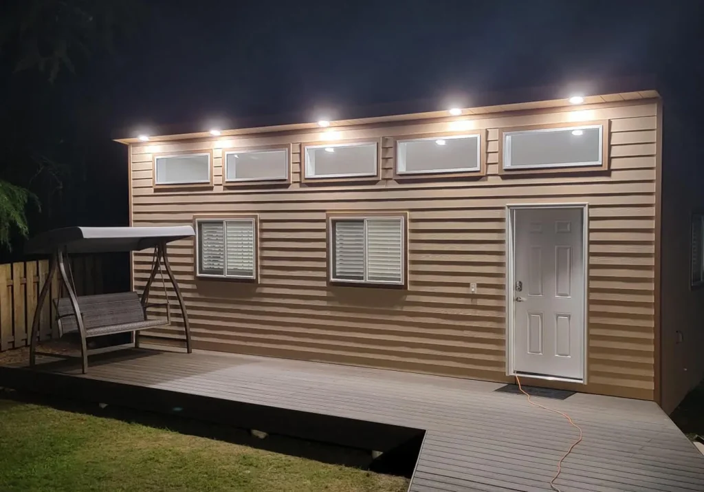 Backyard studio with exterior LED lighting and composite deck